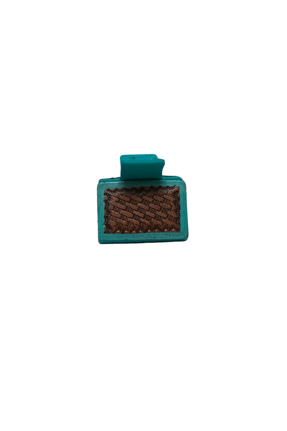 A tooled leather and cowhide hair claw with a metal clasp.