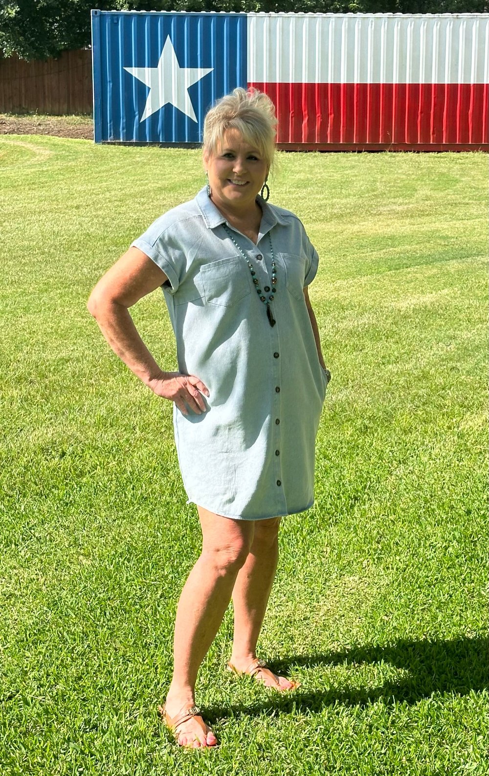 blue button down washed twill shirt dress with side pockets.