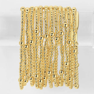 Gold beaded bracelet on a white background