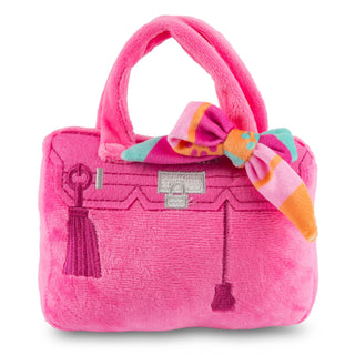 Pink plush handbag with a colorful bow on a white background