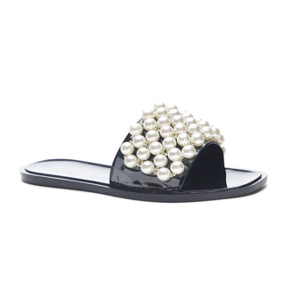 Black slide sandal with pearl embellishments on a white background