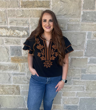 Solid crinkle top with floral applique detail