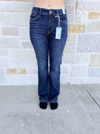 Blue jeans with a tag on a stone wall background