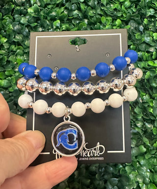 A silicone stack bracelet featuring blue and white beads with a silver charm, displayed on a card with the brand 'Heartland'.