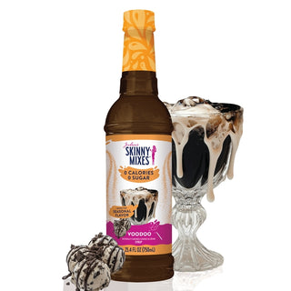 Bottle of Skinny Mixes VooDoo flavor syrup with a glass of ice cream and cookies on a white background