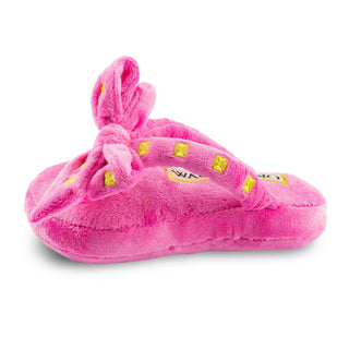 Pink plush slipper with a bow on a white background