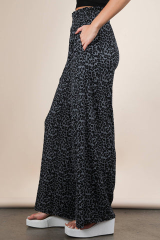 Leopard print wide-leg pants worn by a person on a beige background